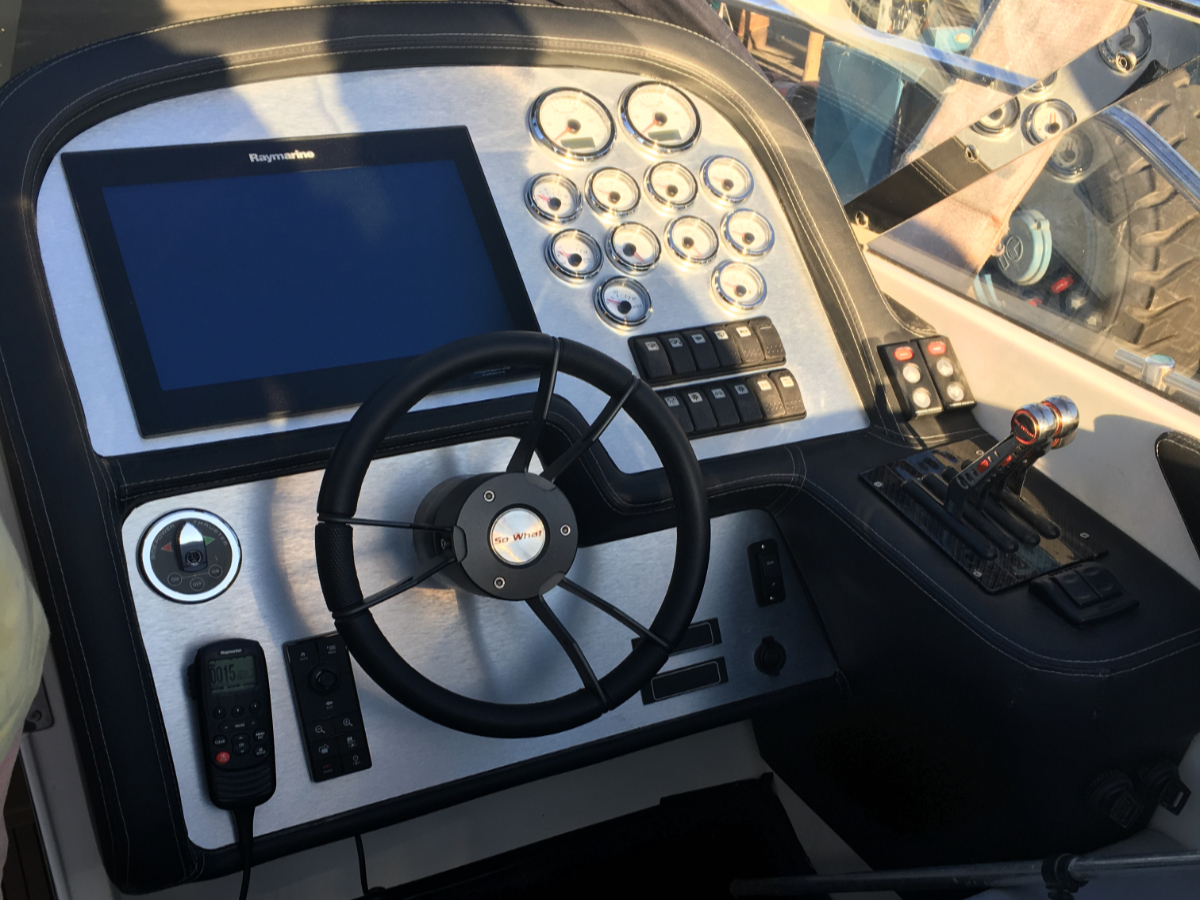Boat steering wheel centre and throttles detailed with stainless steel features