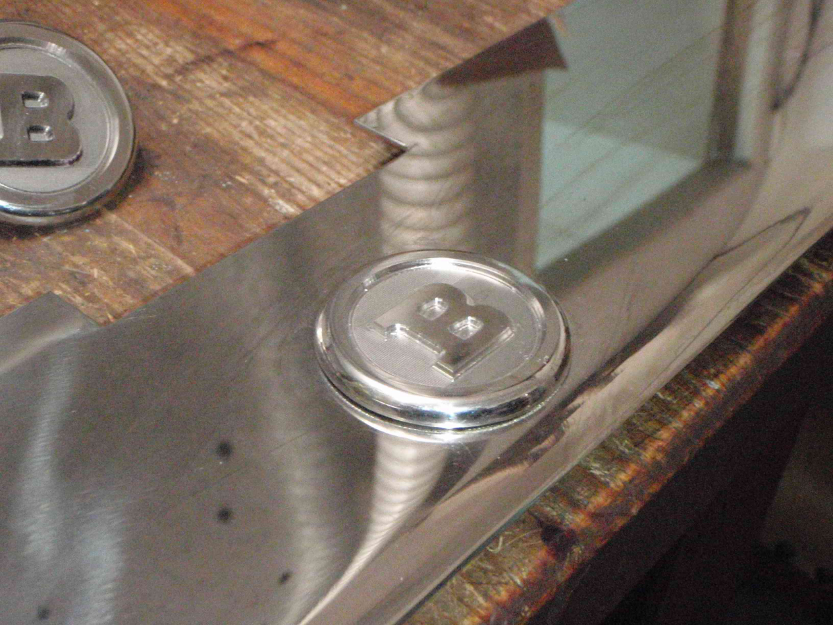 Car logo disc detailed in stainless steel