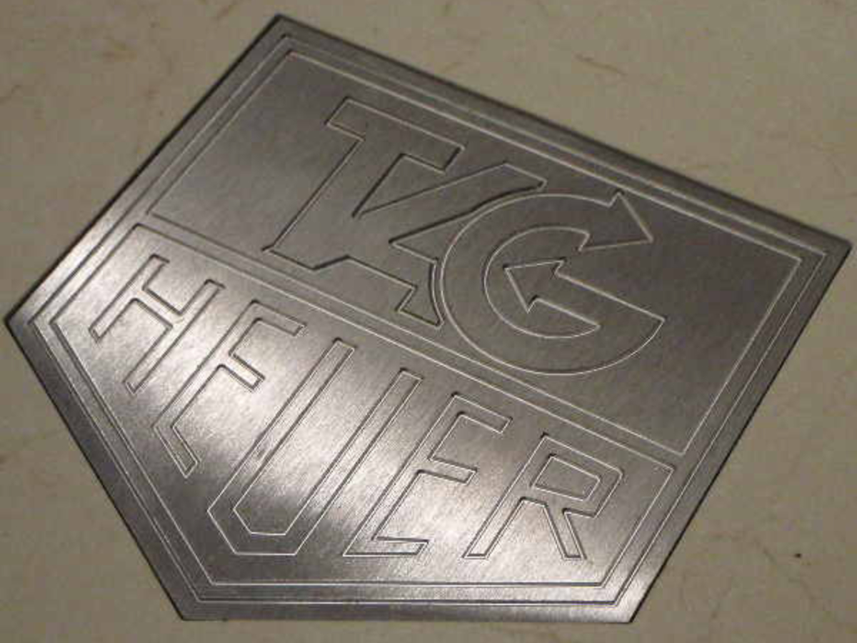 Stainless steel engraved Tag Heuer logo set in floor at Tag Boutique